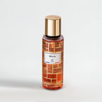 Perfume bottle labeled 'Bella' with gold cap on a light gray background