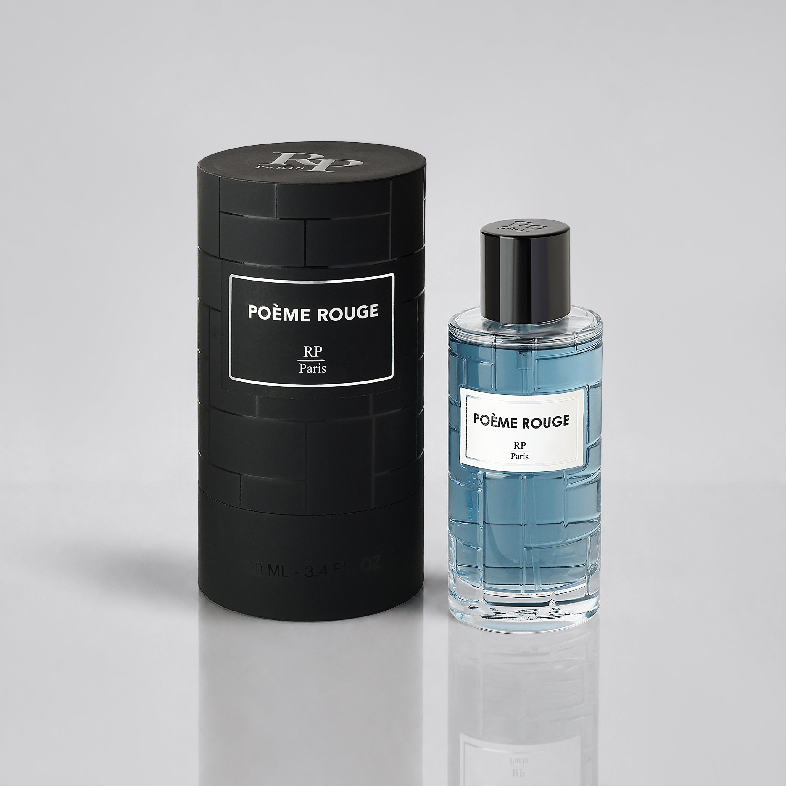 Poème Rouge perfume bottle and packaging on a gray background