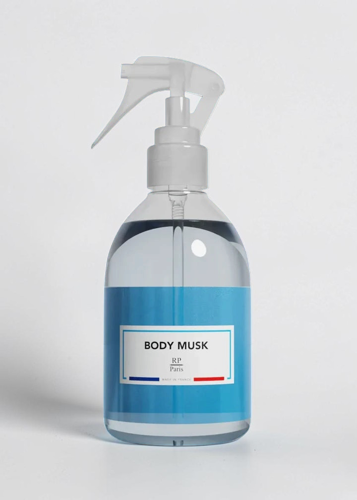 RP PARIS Body Musk scented fabric spray in a clear plastic bottle with a white trigger sprayer on a blue background.