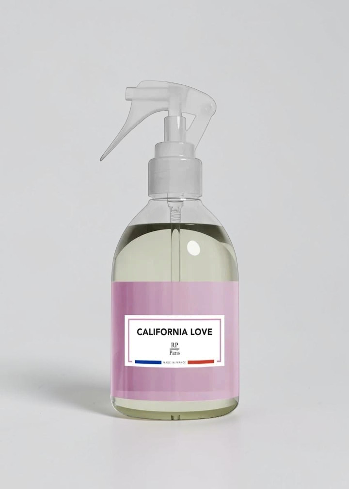 RP PARIS California Love scented fabric spray in a clear bottle with a light pink label and white trigger sprayer.