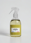 RP PARIS Caramel Gourmand scented fabric spray in a clear bottle with a yellow label and trigger sprayer