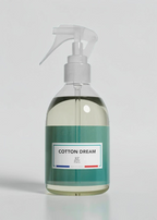 RP PARIS Cotton Dream scented fabric spray in a clear bottle with a white trigger sprayer on a green background.