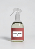 RP PARIS Fleur De Cerisier scented fabric spray in a clear bottle with a red label, made in France.
