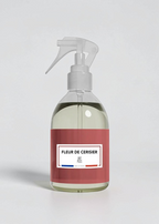 RP PARIS Fleur De Cerisier scented fabric spray in a clear bottle with a red label, made in France.