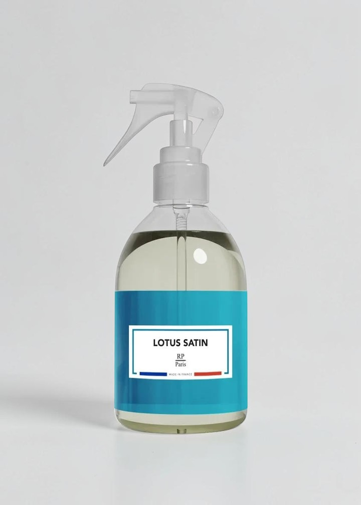 RP PARIS Lotus Satin scented fabric spray in a clear bottle with a blue label, made in France.