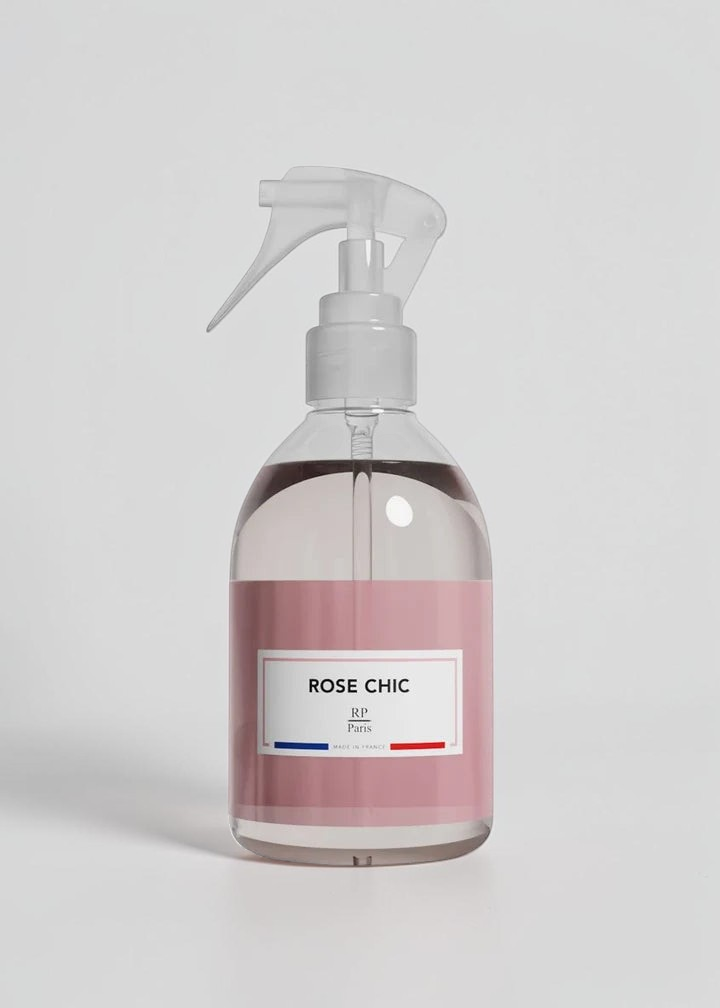 RP PARIS Rose Chic scented fabric spray in a clear bottle with a pink label and white trigger sprayer