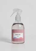RP PARIS Rose Chic scented fabric spray in a clear bottle with a pink label and white trigger sprayer
